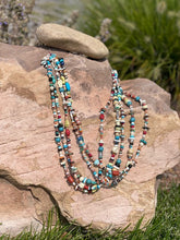 Load image into Gallery viewer, There is Turquoise, Coral, Hubble Glass Beads, Lapiz, Sterling Silver beads, and Stones all strung together on a braided 34" rope.
